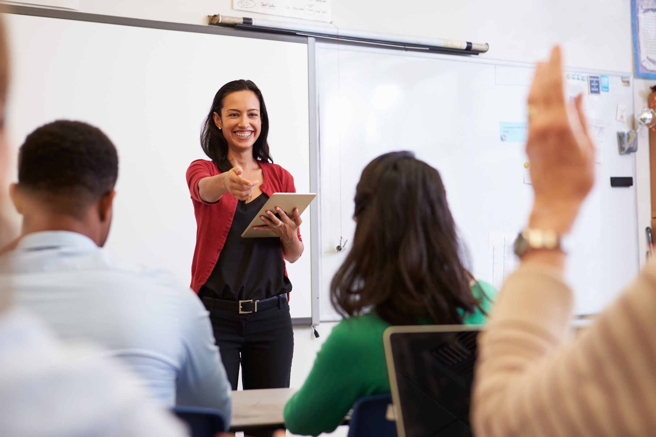 Teacher with tablet and students at an adult education class