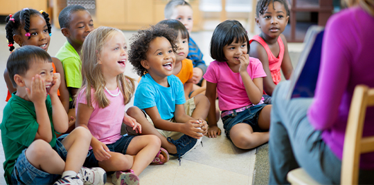 Preschool children in a classroom for story time.