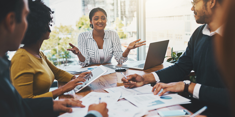 A diverse group of people meeting at a conference room table