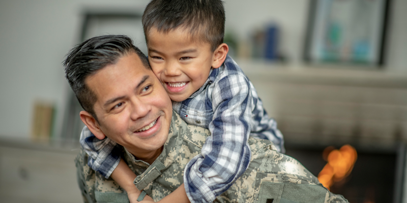 Dad with little boy on his back